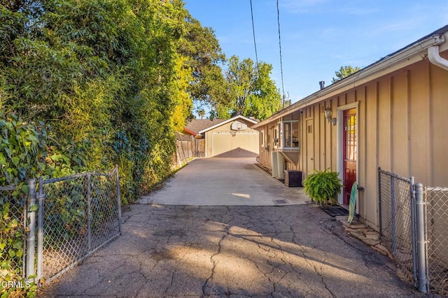 view of side of property featuring board and batten siding, fence, and a gate