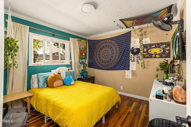 bedroom featuring ornamental molding, wood finished floors, and baseboards