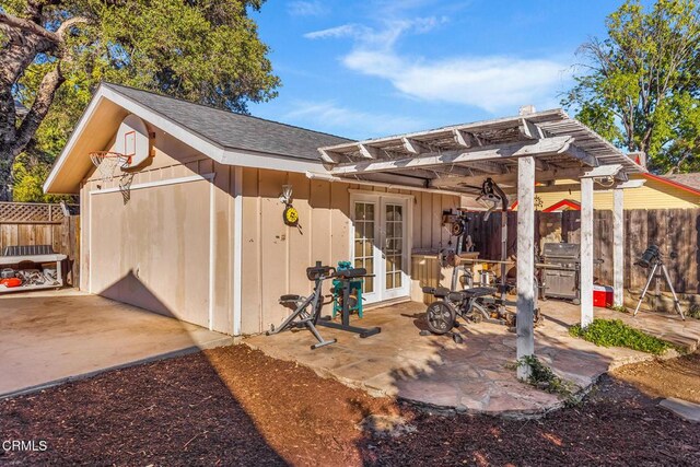 view of patio featuring french doors, fence, area for grilling, and a pergola