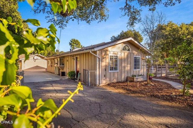 exterior space with board and batten siding and fence