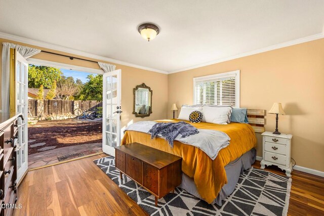 bedroom with ornamental molding, access to outside, baseboards, and wood finished floors