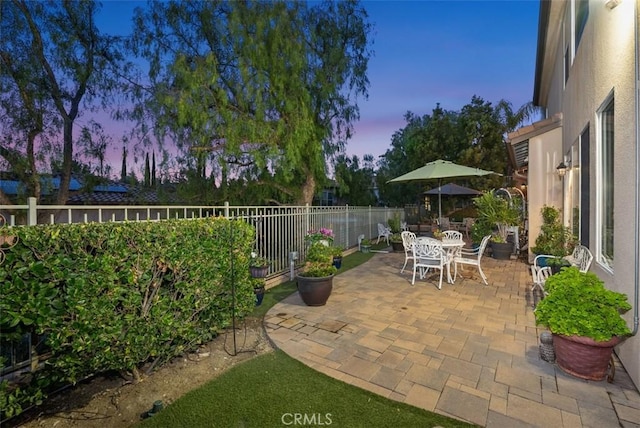 patio terrace at dusk with outdoor dining space