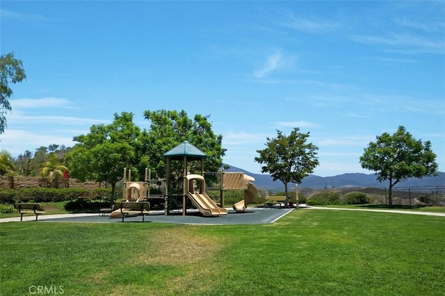 community playground featuring a lawn and a mountain view