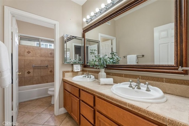 full bathroom featuring tile patterned floors, toilet, double vanity, and a sink