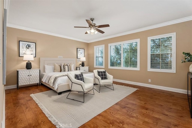 bedroom with crown molding, wood finished floors, baseboards, and ceiling fan