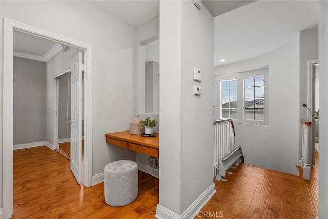 hall with baseboards and wood finished floors