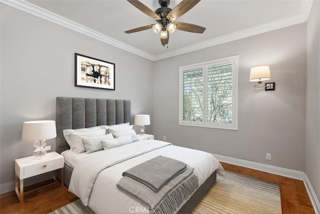 bedroom featuring ornamental molding, a ceiling fan, baseboards, and wood finished floors