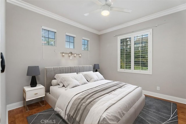 bedroom featuring wood finished floors, baseboards, ornamental molding, and a ceiling fan