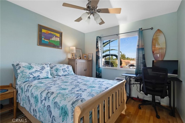 bedroom featuring wood finished floors and a ceiling fan