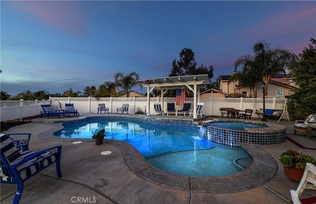 view of pool featuring a pool with connected hot tub, fence, a pergola, and a patio