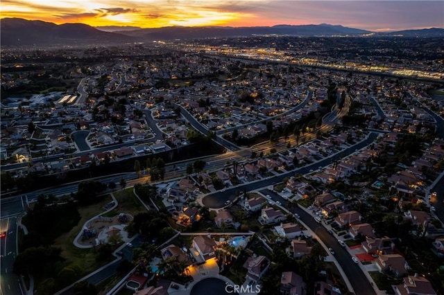 aerial view at dusk featuring a mountain view