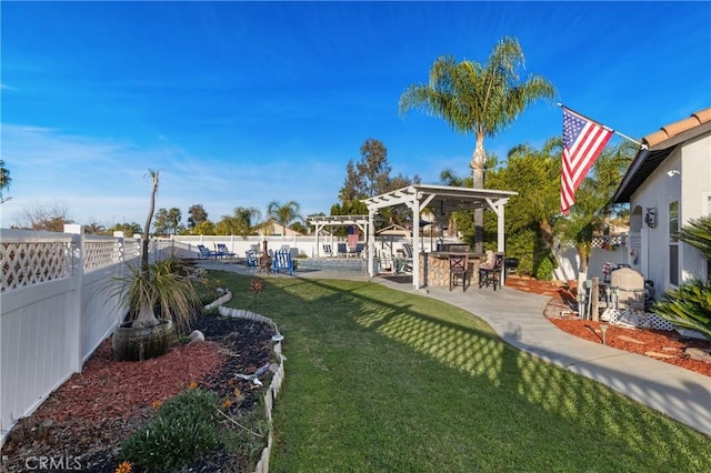 view of yard featuring a fenced backyard, a patio, outdoor dry bar, and a pergola