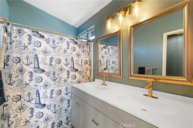 full bath with lofted ceiling, a sink, a shower with shower curtain, and double vanity