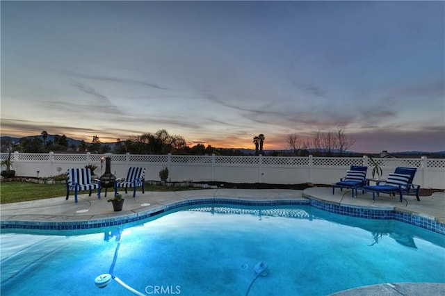 view of swimming pool with fence, a fenced in pool, and a patio