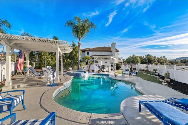 view of pool featuring a fenced backyard, a pool with connected hot tub, a pergola, and a patio