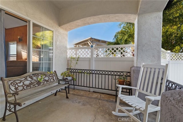 view of patio featuring fence