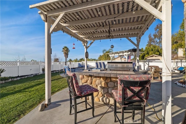 view of patio with outdoor dry bar, area for grilling, a grill, fence, and a pergola