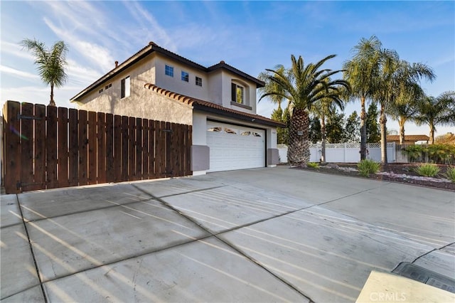 view of property exterior featuring a garage, a tile roof, fence, concrete driveway, and stucco siding