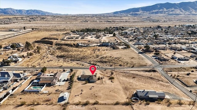 birds eye view of property with a mountain view