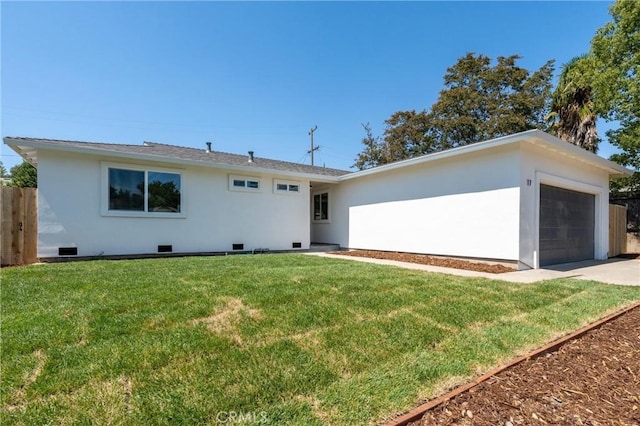 ranch-style home featuring a garage and a front lawn