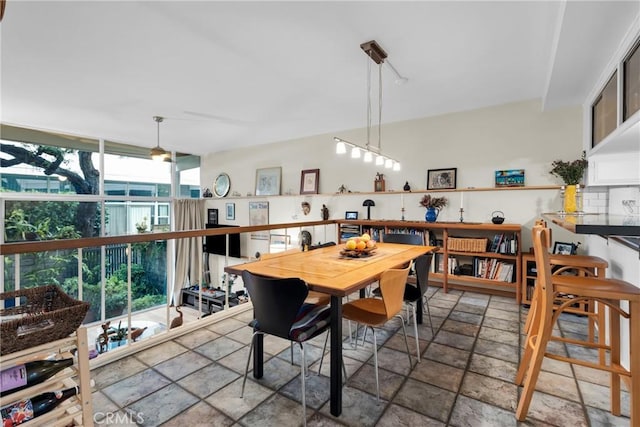 dining space with a wall of windows