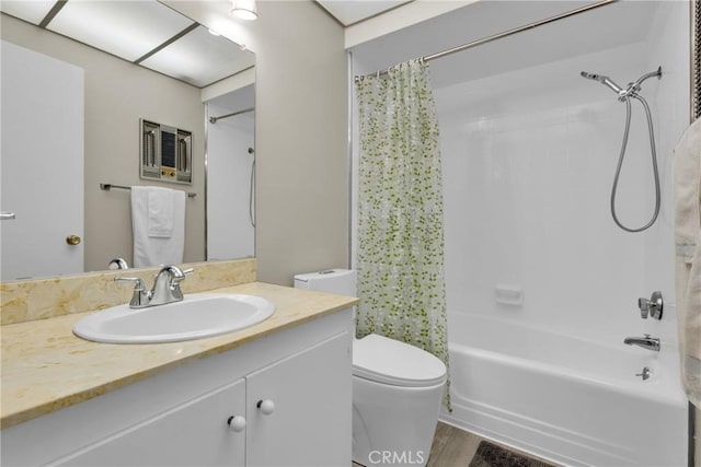 full bathroom featuring vanity, hardwood / wood-style floors, shower / tub combo, and toilet