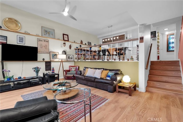 living room featuring ceiling fan and light hardwood / wood-style floors