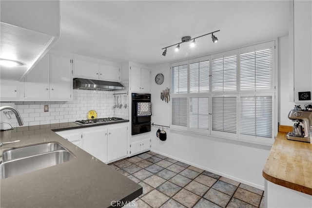 kitchen with white cabinetry, sink, oven, and decorative backsplash