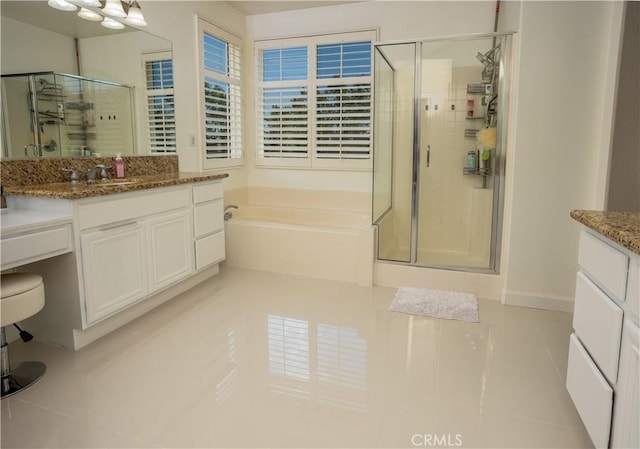 full bath featuring a stall shower, vanity, a bath, and tile patterned floors