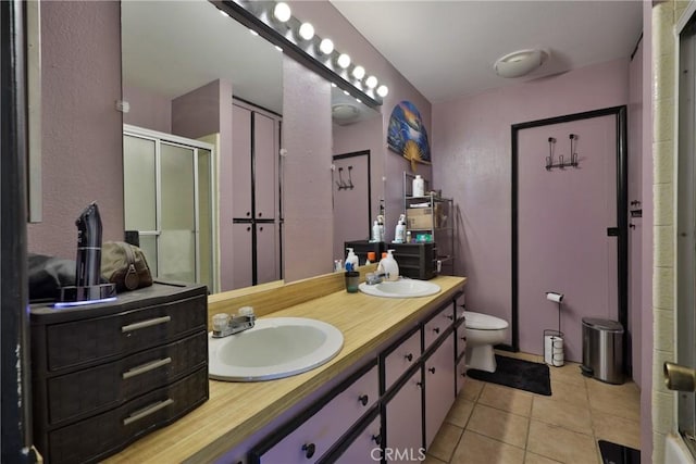 bathroom featuring an enclosed shower, vanity, tile patterned floors, and toilet