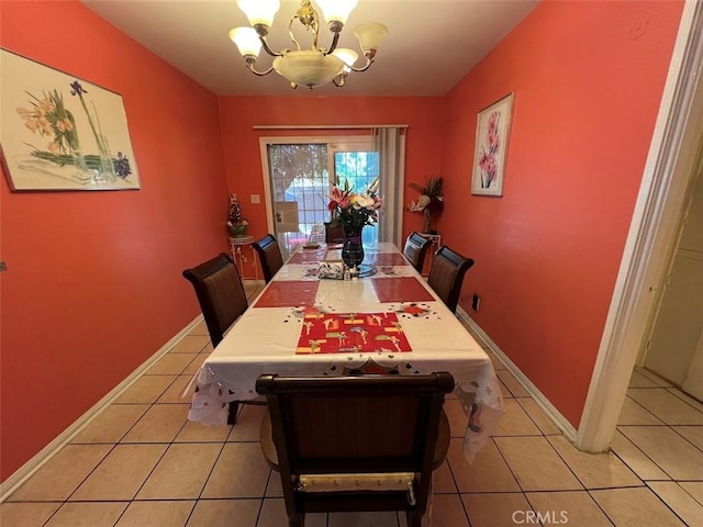 tiled dining area with a notable chandelier