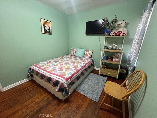 bedroom with dark hardwood / wood-style flooring