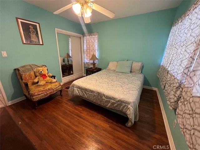 bedroom with hardwood / wood-style flooring, ceiling fan, and a closet