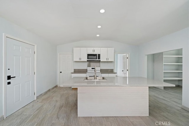69719 Palm Springs Ave, Mountain Center, CA 92561 - kitchen featuring vaulted ceiling, a sink, a center island with sink, light countertops, and white cabinets