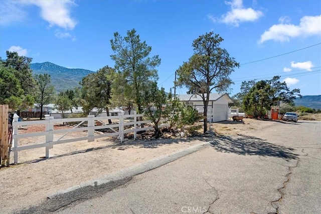 69719 Palm Springs Ave, Mountain Center, CA 92561 - view of front facade with an outbuilding, fence, and a mountain view