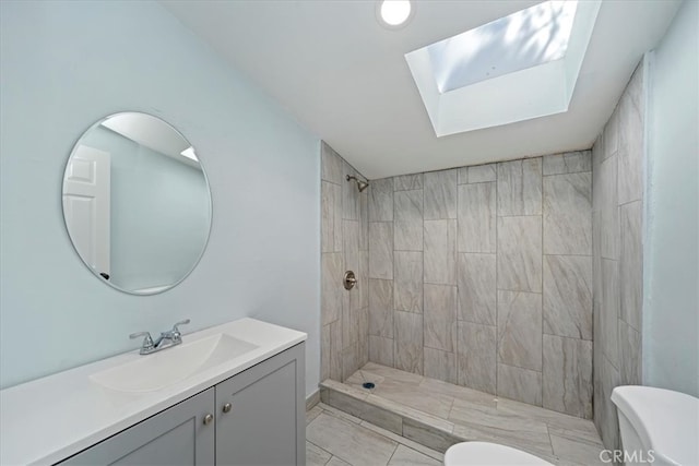 69719 Palm Springs Ave, Mountain Center, CA 92561 - full bath featuring a tile shower, toilet, vanity, and a skylight