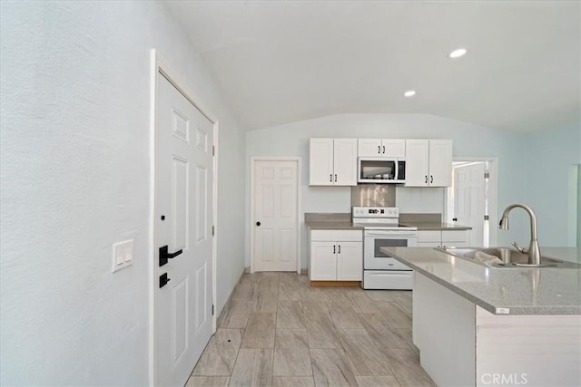 69719 Palm Springs Ave, Mountain Center, CA 92561 - kitchen with white cabinets, vaulted ceiling, white electric range, and a sink