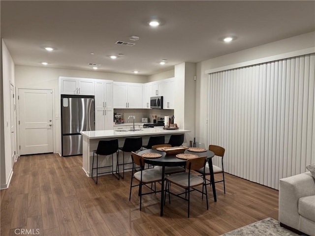 3620 S Allston Paseo Unit 7, Ontario, CA 91761 - dining room with visible vents, recessed lighting, and dark wood-style flooring