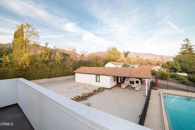 balcony featuring a mountain view and a patio area