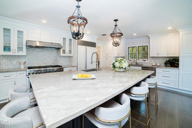 kitchen with white cabinetry, a breakfast bar area, and a large island