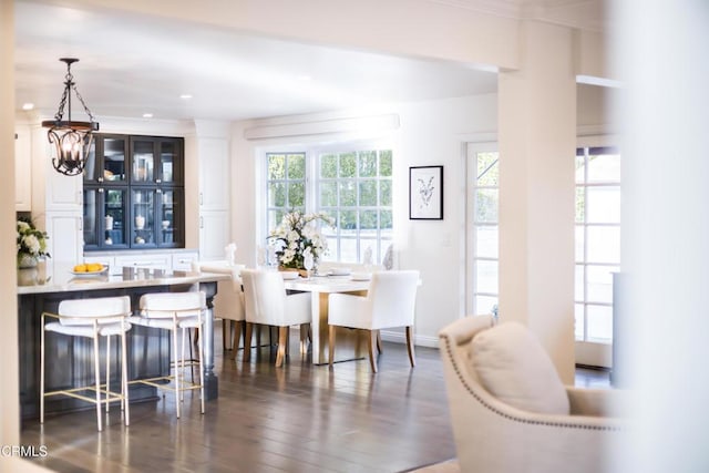 dining room with dark hardwood / wood-style floors and an inviting chandelier