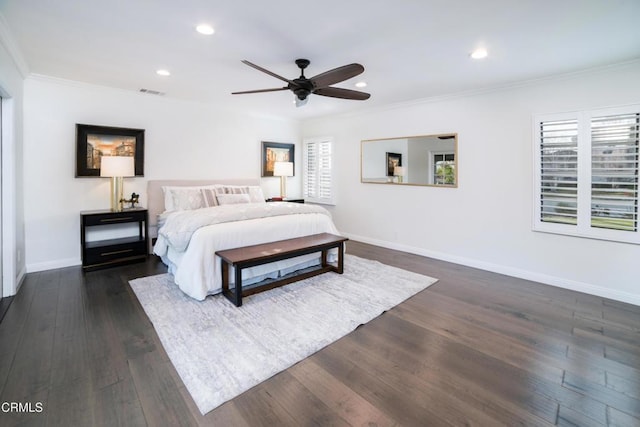 bedroom featuring dark hardwood / wood-style flooring, ornamental molding, and ceiling fan