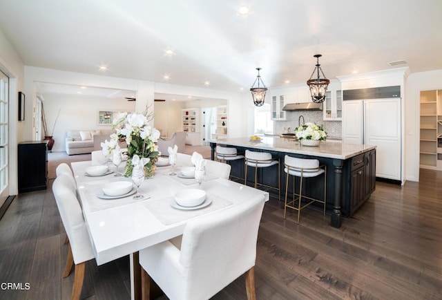 dining area featuring dark wood-type flooring and a notable chandelier