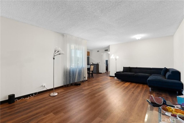 living room with a textured ceiling and hardwood / wood-style floors