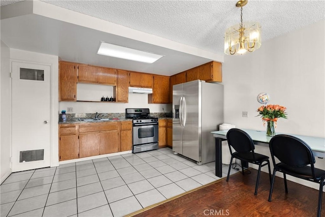 420 W Windsor Rd, Glendale, CA 91204 - kitchen with appliances with stainless steel finishes, under cabinet range hood, a sink, a textured ceiling, and brown cabinets