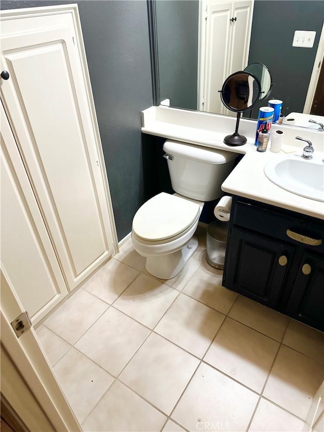 bathroom with tile patterned flooring, vanity, and toilet