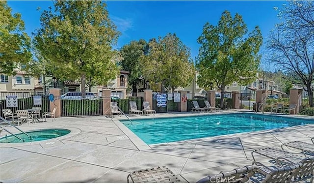 view of pool featuring a patio and a community hot tub