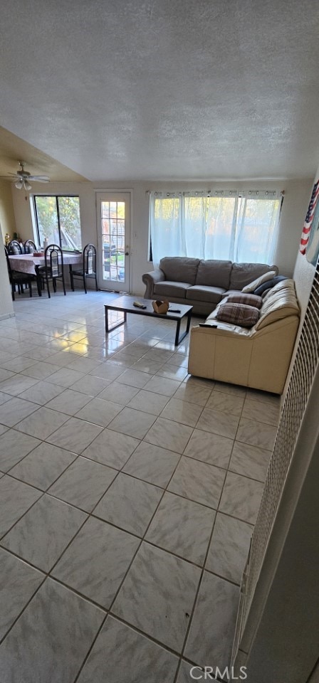 unfurnished living room with light tile patterned floors and a textured ceiling