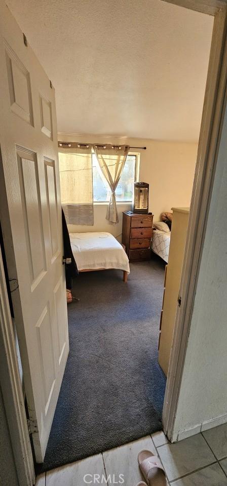 bedroom with carpet floors and a textured ceiling