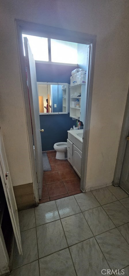 bathroom featuring vanity, toilet, and tile patterned flooring